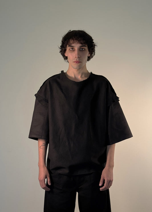ORIGINAL T-Shirt, Shme-Shno, Hungarian brand, Budapest-founded, handcrafted in Toronto, unisex black oversized shirt, avant-garde fashion, minimalist streetwear, heavyweight premium cotton, sculptural silhouette, raw seams, hand-finished edges, Varrni stitching technique, artisanal craftsmanship, contemporary brutalist aesthetics, cultural heritage meets modern design, limited edition, luxury streetwear, heritage-inspired fashion.

