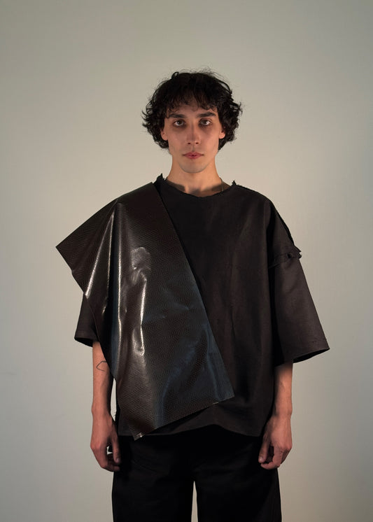 EmpError T-Shirt, Shme-Shno, Budapest-origin, Canadian-made, oversized black shirt, avant-garde fashion, experimental streetwear, sculptural statement piece, genderless design, brutalist fashion, varrni sewing technique, asymmetrical vinyl shoulder panel, post-apocalyptic style, armor-inspired fashion, dystopian aesthetics, crinkled vinyl, raw cut edges, offbeat stitching, conceptual design, minimalism meets chaos, Eastern European streetwear, resistance fashion, limited edition, rare fashion sculpture.