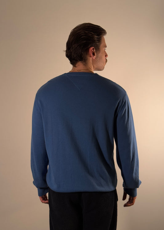 Shme-Shno SHOVNO Sweater in blue, featuring embroidered cross motifs symbolizing the connection between Shme-Shno and Bence Varga. Designed by Hungarian brand Shme-Shno founded in Budapest and crafted in Canada using traditional Hungarian Varrni stitching technique. Soft cotton-blend fabric with V-neck silhouette and ribbed cuffs.